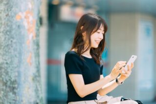 Businesswoman making a reservation on a smartphone